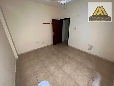A one-bedroom apartment with a living room for annual rent in Al Rashidiya 1, Ajman, in a prime location on Al Mina Street, opposite the fish market,