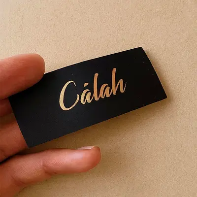 Calah branded clothing label / black satin garment tag