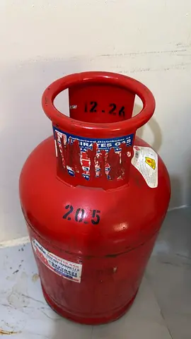 Small red LPG gas cylinder (household) - used, refilled.