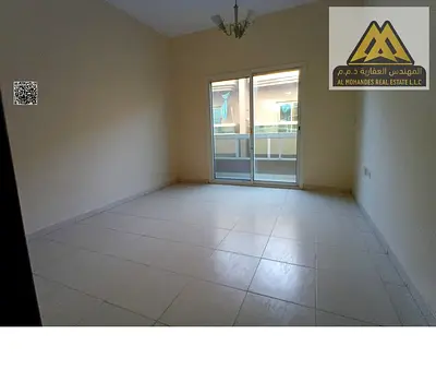 2BR hall in Rashidiya 1, balcony, 2 baths, spacious layout, prime location, AED 40k yearly, 4 payments.