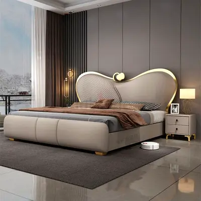 Modern upholstered king-size bed with curved headboard and storage