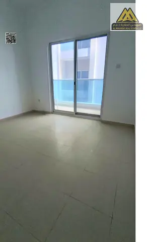For rent: 1-bedroom apartment with hall in Al Nuaimiya 3, City Tower on Sheikh Khalifa Street, 2 bathrooms, balcony, central AC, free maintenance, AED