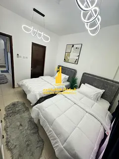 Furnished two-bedroom apartment for monthly rent in Ajman, including utilities, internet, and parkin