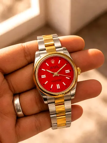 Rolex Oyster Perpetual two-tone watch with red dial