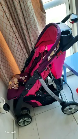 Pink lightweight standard stroller with storage basket - good condition