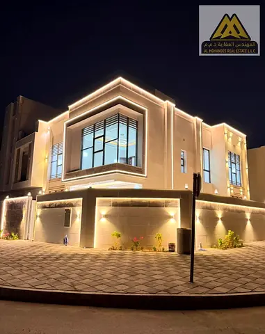 Corner villa for sale in Al Helio 2, Ajman, with a spacious building area and five bedrooms, including registration fees.