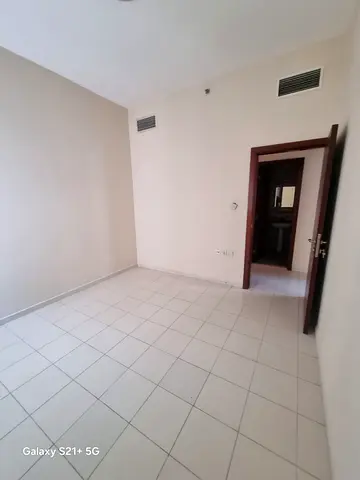 For annual rent: a two-bedroom apartment with a living room for annual rent in Al Qasmiyah - Sharjah, in a lively location close to all services.