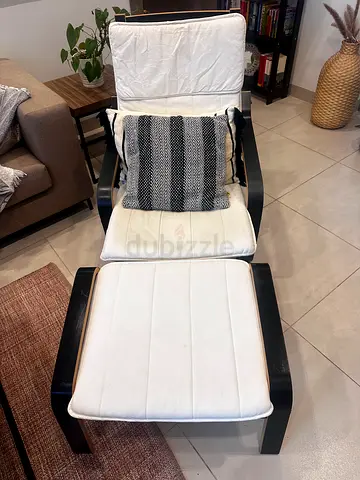 Comfortable White Lounge Chair with Matching Ottoman and pillows