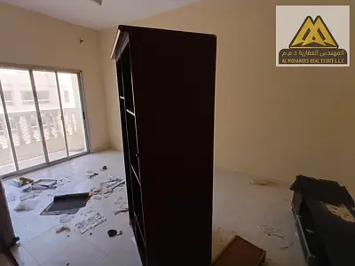 1-bedroom apartment in Al Rashidiya 1 with separate living room, balcony, and central AC. AED 30K yearly, 6 payments. Prime location near all services