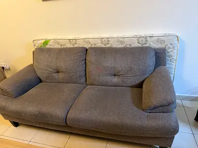 Grey 2-seater  2-seater sofa in good condition with spare mattress