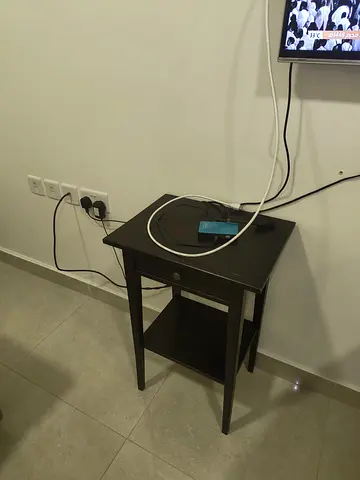 Small dark wood side table with drawer and lower shelf