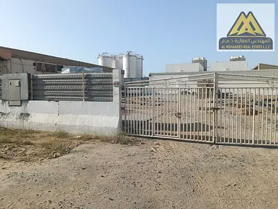 Commercial Yard for Rent in Al Jurf Industrial 2, 2 Equipped Offices Large Storage and Operational Space Easy Truck Access Strategic Industrial ocati