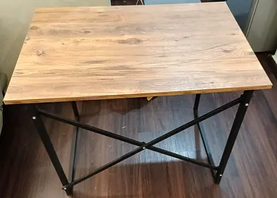 Compact industrial-style wooden top folding table, strong and durable table for 100 Aed only