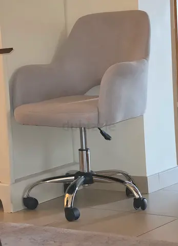 Grey upholstered swivel office chair with wheels