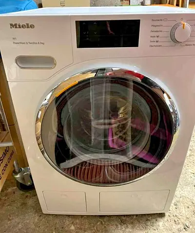 Miele W1 washing machine, specifically a model featuring PowerWash, TwinDos, and a 9kg load capacity