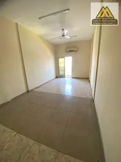 The studio features a large space, a balcony, a separate kitchen, split AC, and free maintenance by