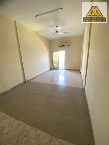 The studio features a large space, a balcony, a separate kitchen, split AC, and free maintenance by the landlord, offering comfortable and affordable