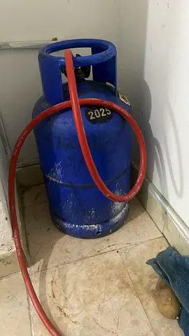 Used blue LPG gas cylinder with hose - good working condition