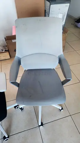 Ergonomic grey office chair with armrests and wheels - used