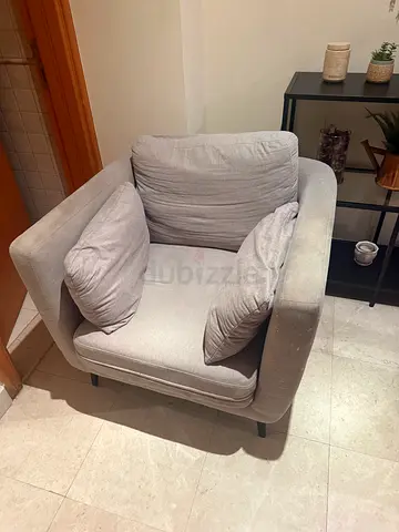 Light grey single armchair with cushions