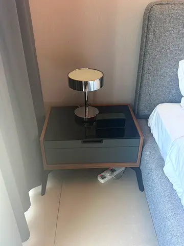 Modern bedside nightstand with glass top and wooden frame