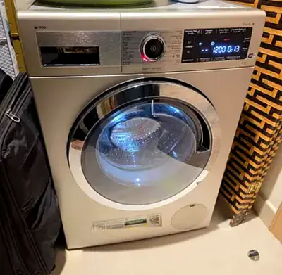 Bosch Series 8 front load washing machine with a silver inox finish.It features an EcoSilence Drive