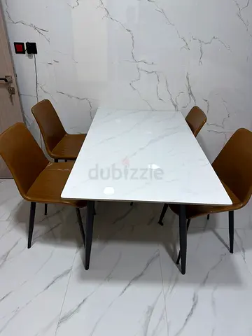 Modern white marble-top dining table with 4 wooden chairs