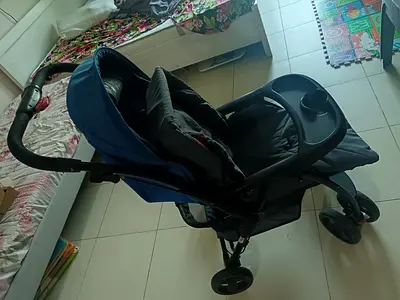 Juniors brand. Well-maintained black and blue baby stroller with snack tray