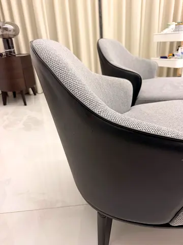 Pair of modern grey fabric leather black shell lounge chairs