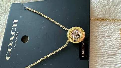 Coach gold-tone pendant necklace with crystal detail, new on card