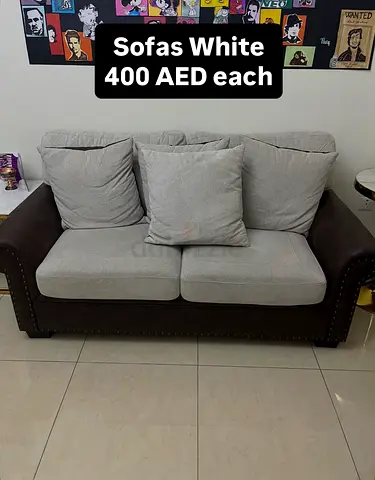 Two-seater sofa in beige fabric with dark faux-leather arms - good condition