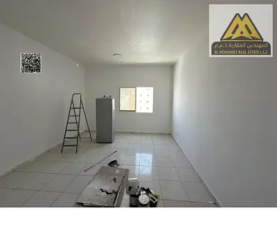 Large studio in Rashidiya 3, Ajman, 20,000 AED yearly, 4 payments, central AC, near Corniche, opposite Ajman One, parking available.