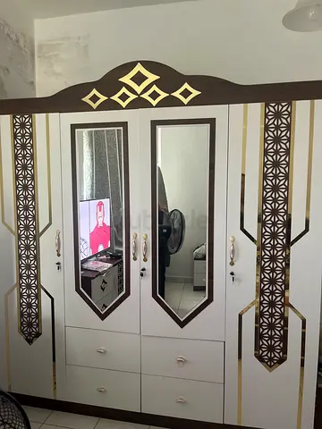 White and brown full-size wardrobe with mirrored doors and drawers