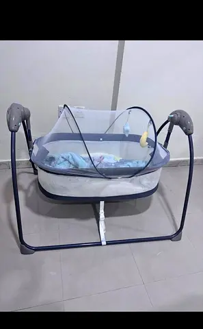 Portable baby cradle rocker with mosquito net and toys - gently used