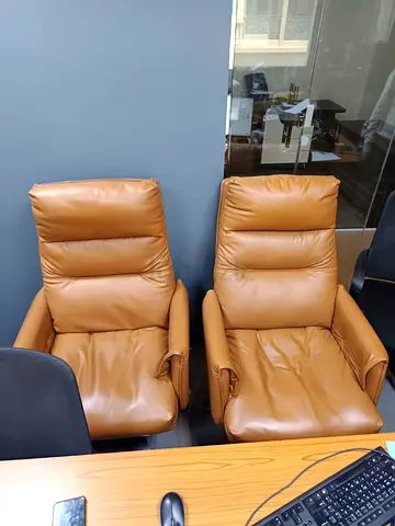Pair of brown leather office recliner chairs — good condition