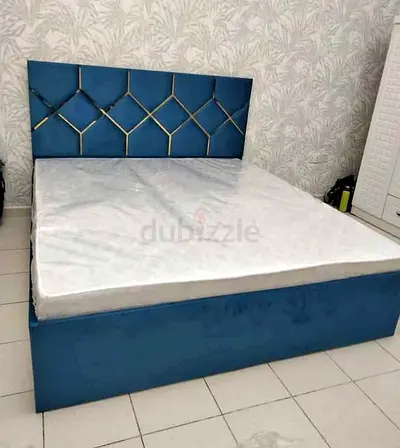Blue upholstered double bed with storage base and mattress