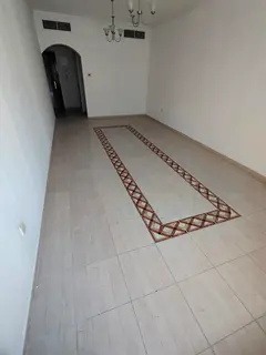 For rent in Al Taawun, Sharjah: Spacious 2-bedroom apartment with living room, 2 bathrooms, free AC.
