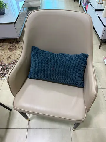 Modern beige accent armchair with navy cushion — good condition