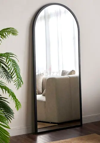 Full-length arched leaning mirror with slim black frame