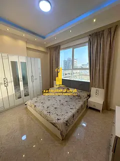 Luxury apartment, second occupancy, two bedrooms, living room, and balcony with an open view. Ajman