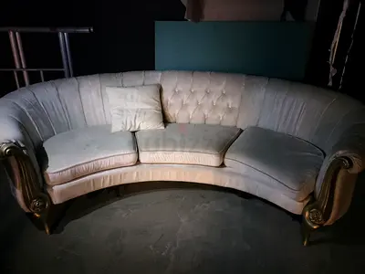 Curved tufted sofa in cream with gold legs