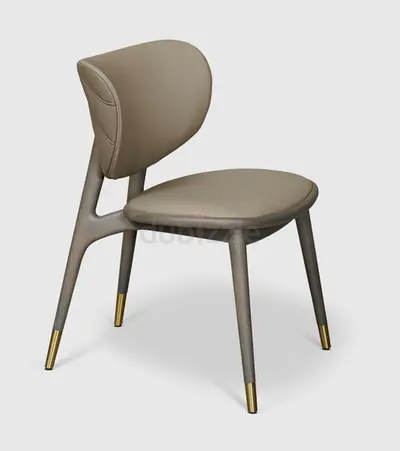 Modern upholstered dining chair with brass-tipped legs