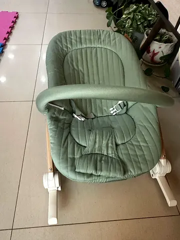 Green baby bouncer / rocker in good condition with baby play mat