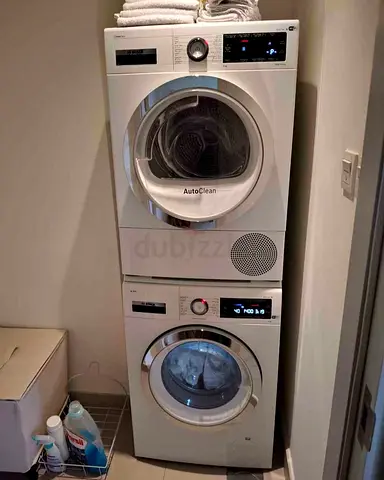 Bosch Series 8 washing machine and dryer stacked vertically, featuring AutoClean technology.The unit