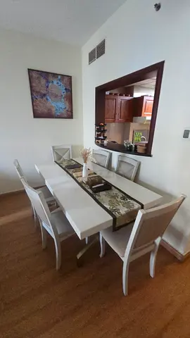 White wooden 6-seater dining table with glass top and chairs
