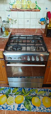 Used freestanding stainless steel gas oven with multiple racks - good condition