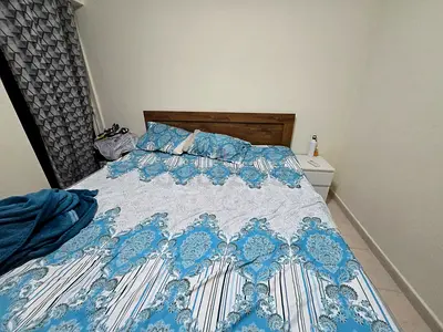Wooden double bed with mattress and bedside table included