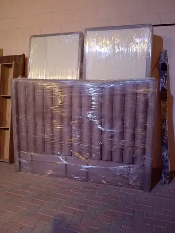 Gray bed with mattress