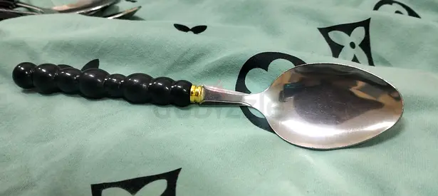 Set of decorative stainless steel teaspoons with black beaded handles (single shown)