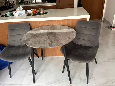 Small round dining table with two grey upholstered chairs - set of 3